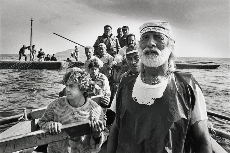 Black and white photo by Salgado of Favignana tonnara fishermen on a wooden boat in Sicily