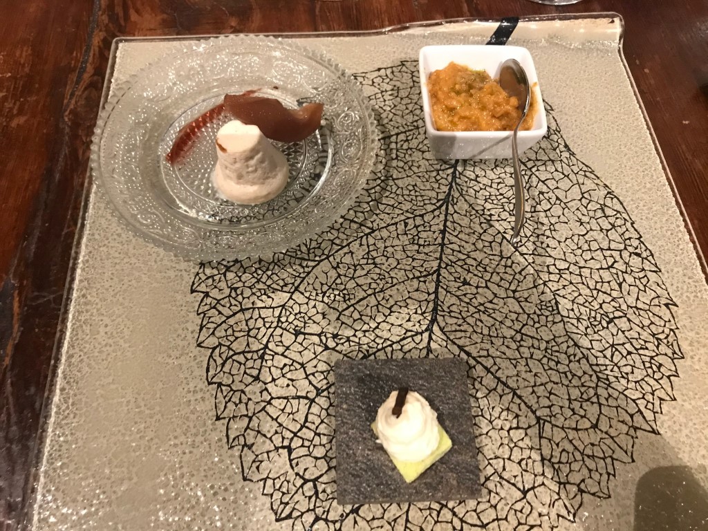 Artistic dessert platter at Osteria I'Ciocio, Suvereto, with three sweet components on a leaf-etched tray