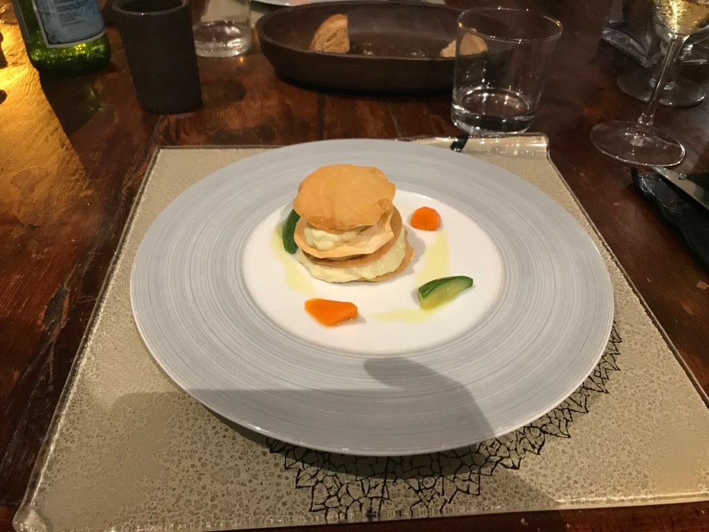 Elegant plated starter at Osteria I'Ciocio, Suvereto, with pastry, cream, and garden vegetables