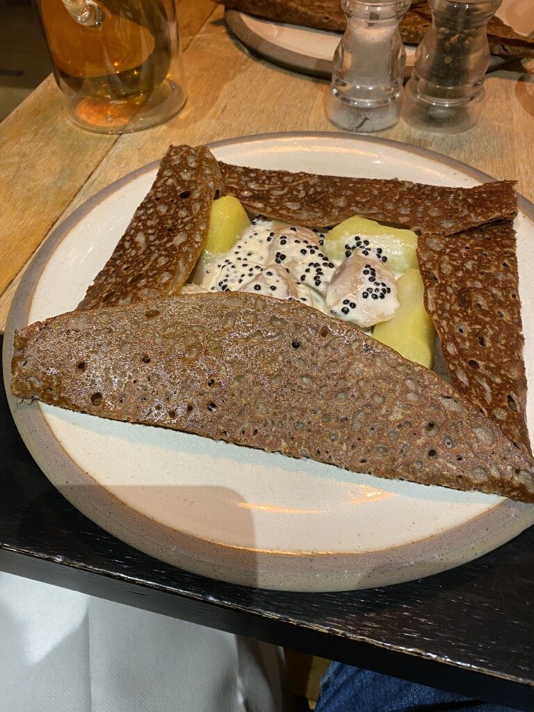 Buckwheat galette filled with oysters, potato, and cream sauce served in Cancale, Brittany
