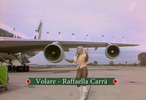 Raffaella Carrà dancing on the tarmac in front of an Alitalia jet in her Volare music video