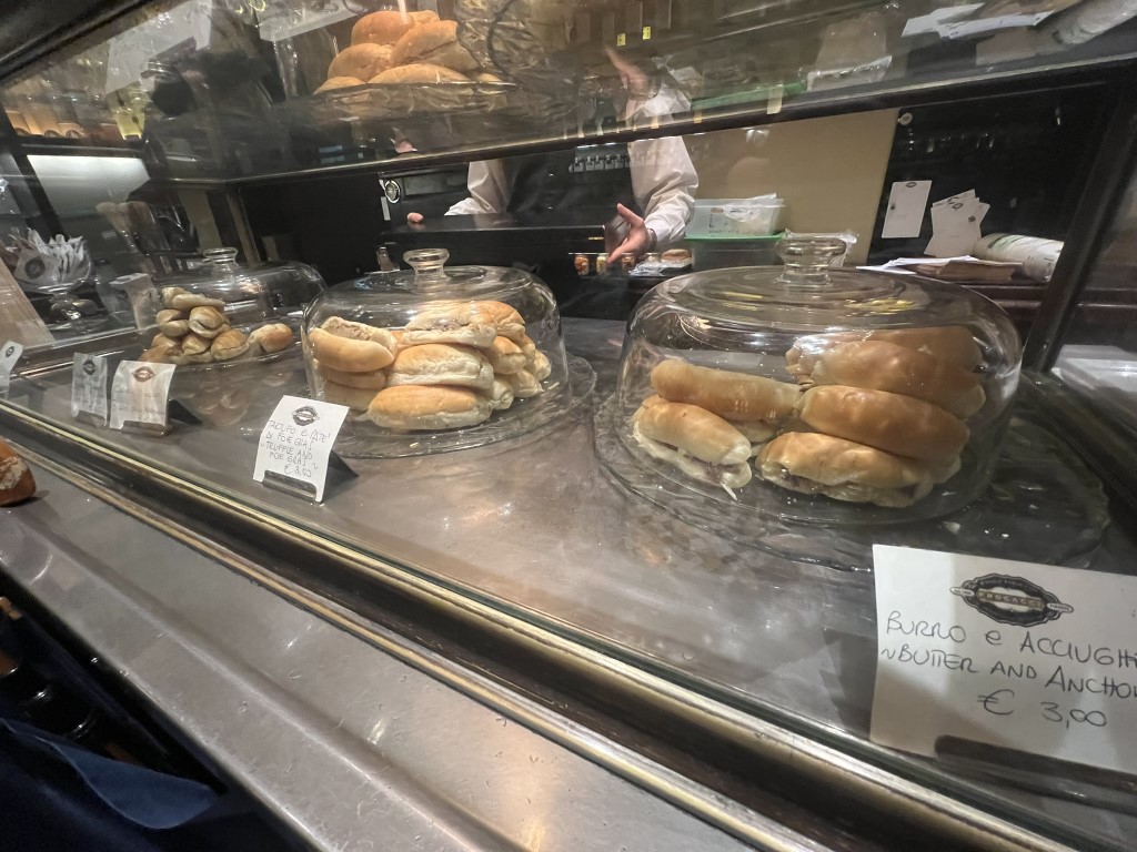 Glass counter display at Procacci 1885 Florence, showing burro e acciughe (butter and anchovy) tramezzini rolls