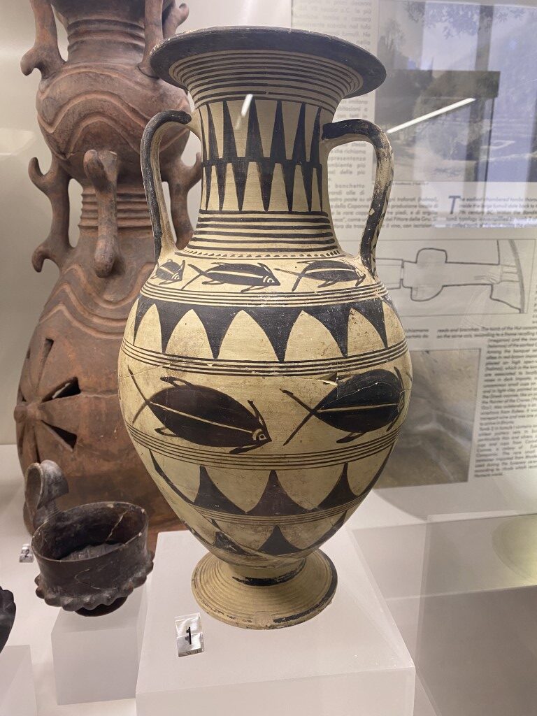 Ancient Etruscan amphora with fish motifs on display at Villa Giulia Museum, Rome