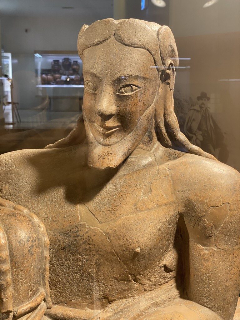 Terracotta female figure with archaic smile on display at Villa Giulia Etruscan Museum, Rome