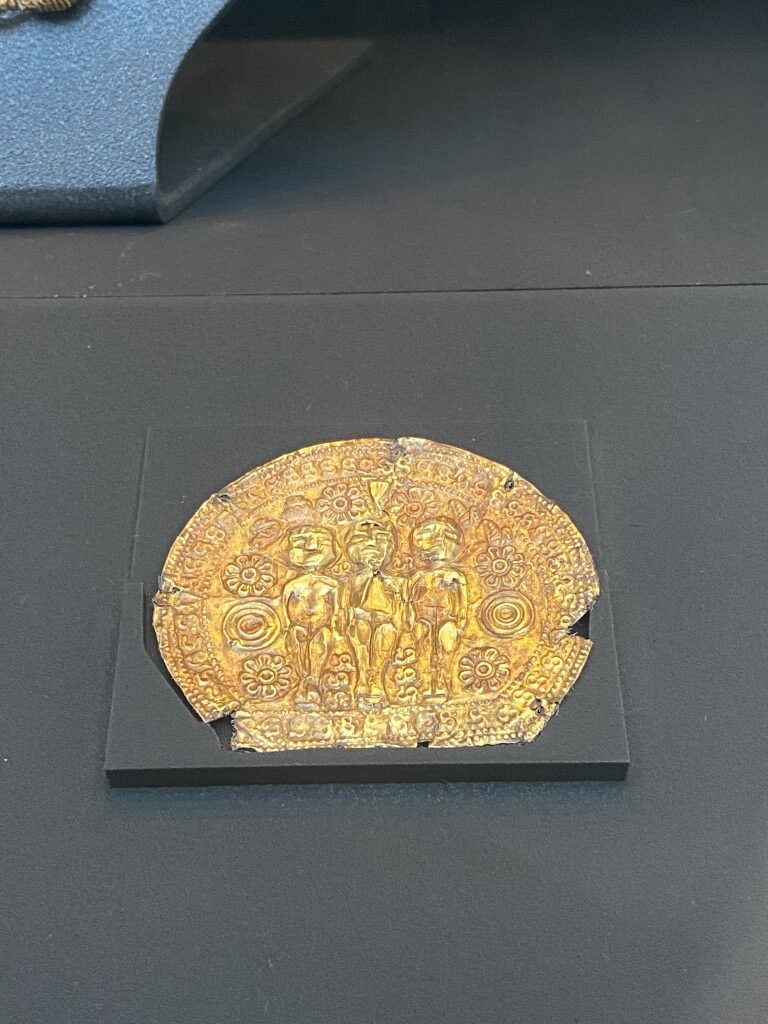 Ancient Etruscan gold roundel with embossed human figures and floral motifs, Villa Giulia museum Rome