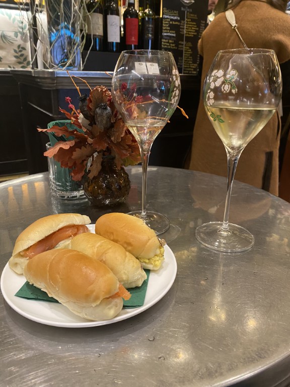 Procacci 1885 truffle rolls and white wine glasses served at the historic Florence bar