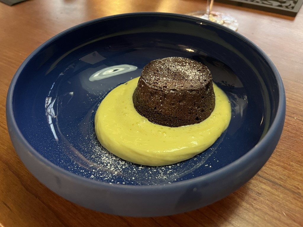 Chocolate lava cake with vanilla custard sauce served at Parlor restaurant in Bologna