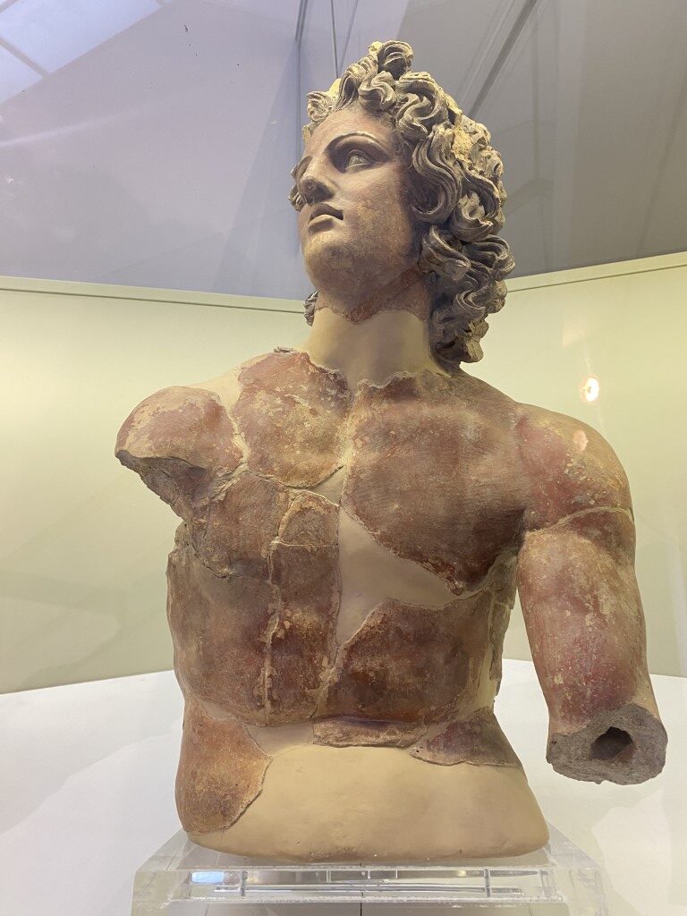 Fragmentary terracotta bust of a young male deity on display at Villa Giulia, Rome