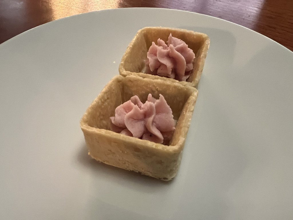 Two savory pastry cups filled with whipped mortadella mousse, a signature amuse-bouche at Parlor Bologna