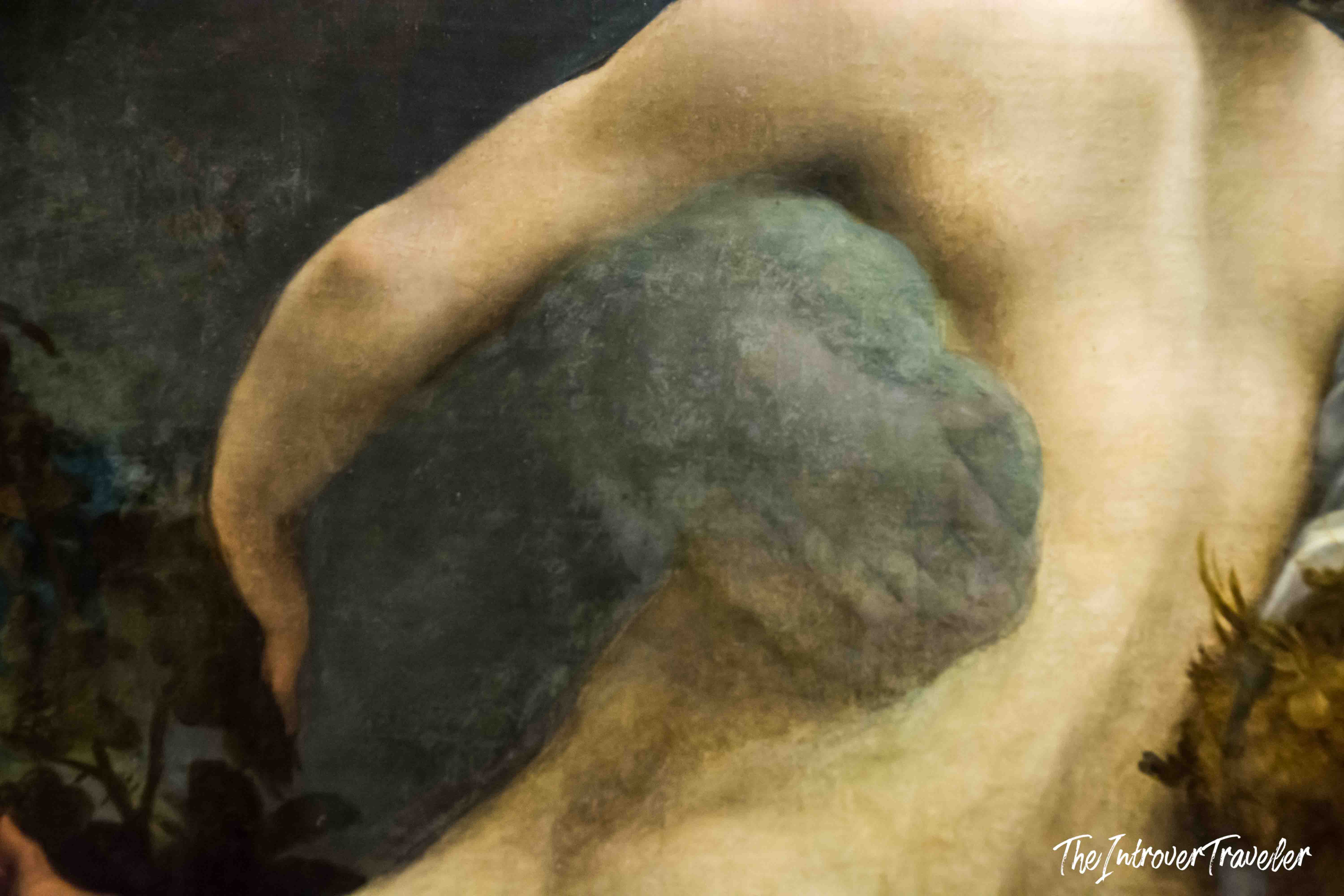 Close-up of Io's arm pressing against Jupiter's cloud form in Correggio's Jupiter and Io painting