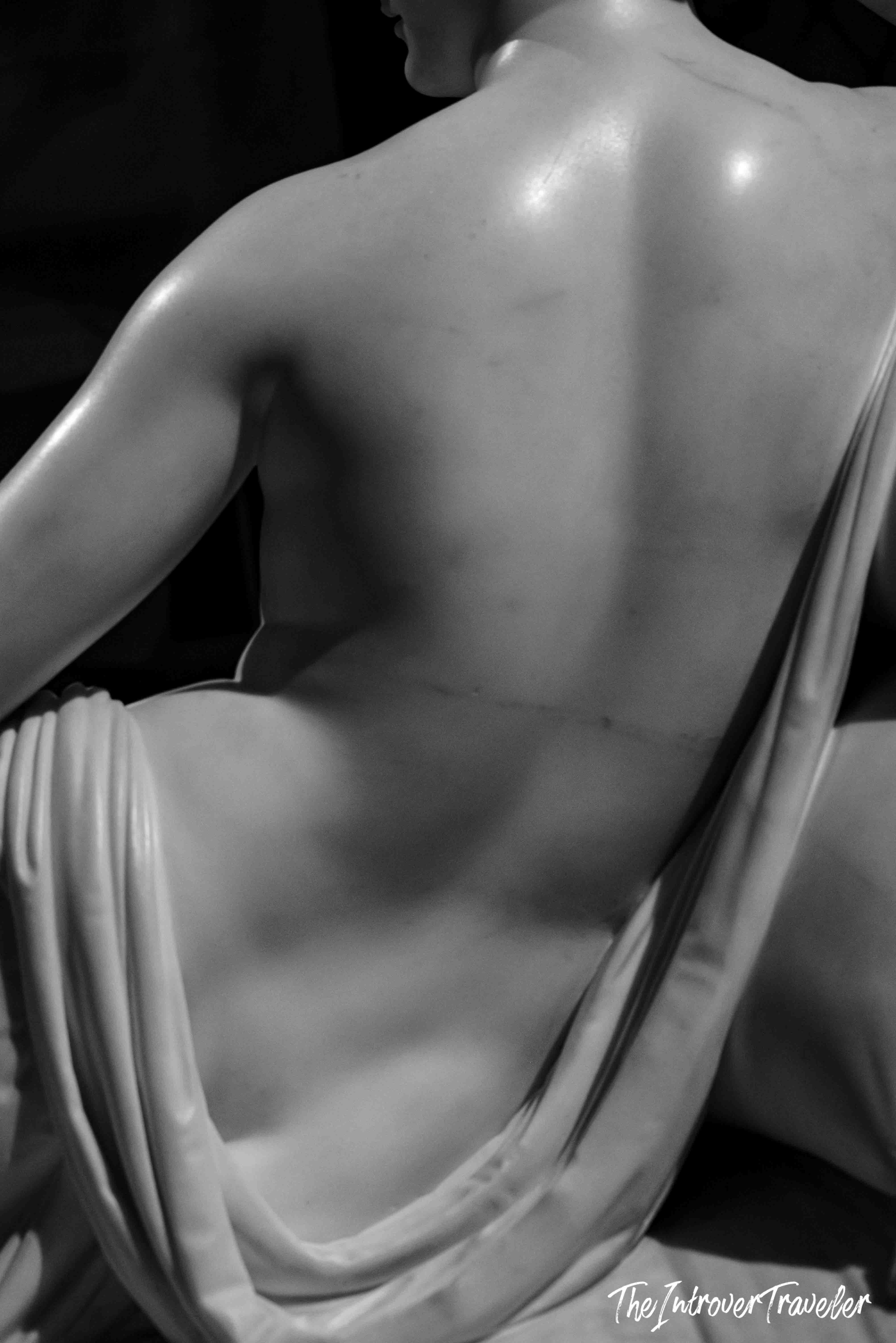 Close-up of Canova's Pauline Borghese sculpture, showing the bare marble back and draped fabric detail