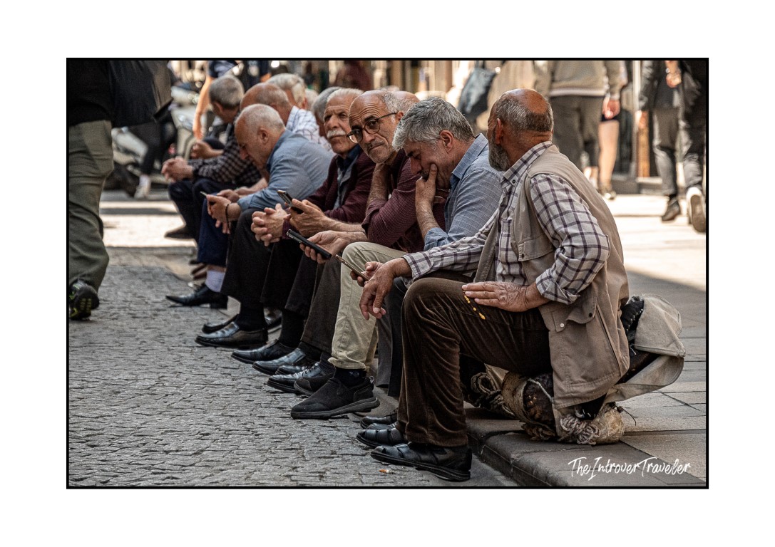 Elderly Turkish men sitting on a curb in Istanbul, a glimpse of local daily life in the city