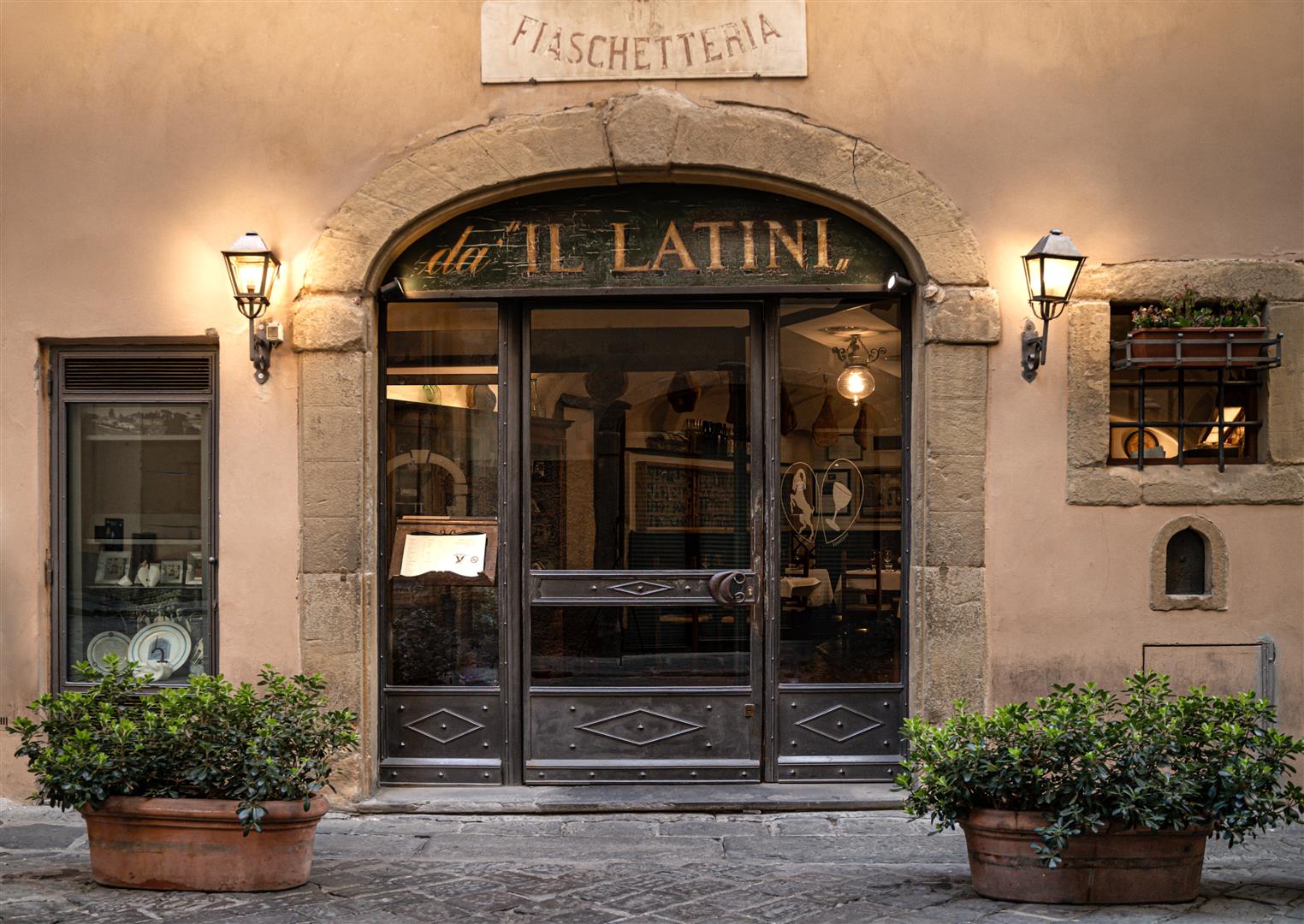 Fiaschetteria da Il Latini entrance in Florence, a historic trattoria on a cobblestone street