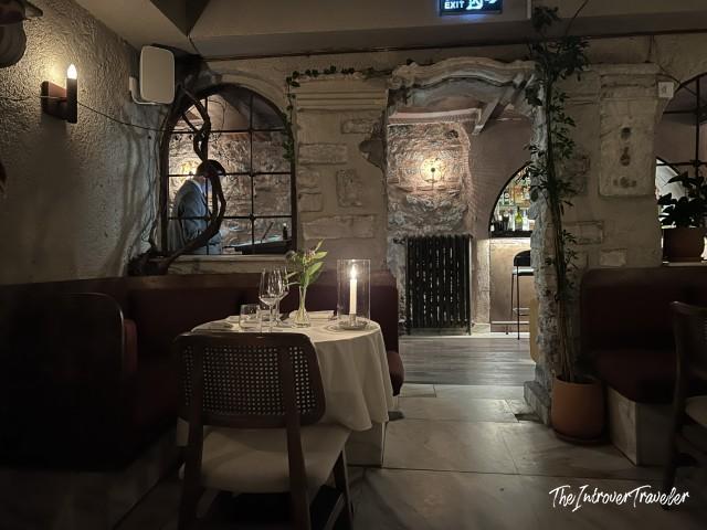 Candlelit dining room at Lokanta 1741 Istanbul, with stone arched walls and elegant table setting