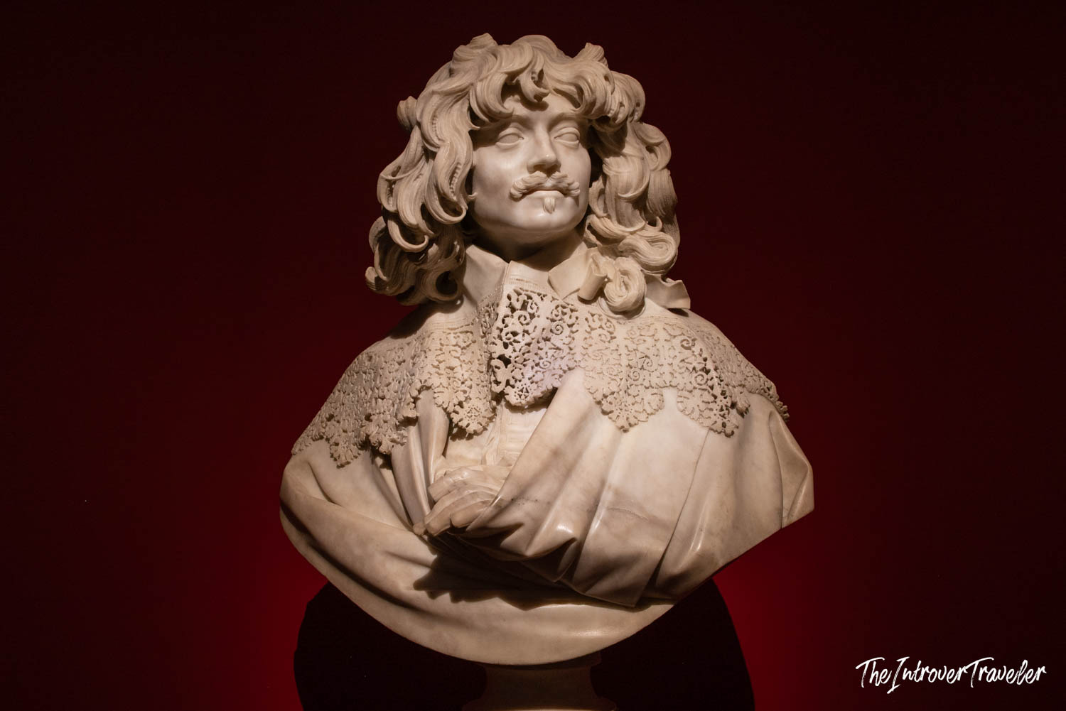 Baroque marble bust by Bernini, showing intricate lace collar and curly hair, displayed at Palazzo Barberini