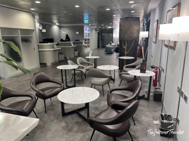 Piranesi Lounge at Milan Linate, seating area with leather chairs and marble tables