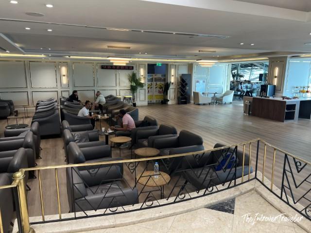 CAC Lounge seating area at Cairo Airport, with rows of black leather armchairs and small tables