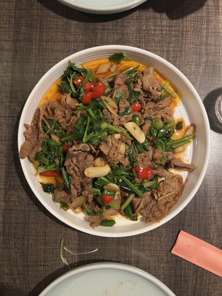 Stir-fried beef with greens and red peppers, part of New York's diverse dining scene