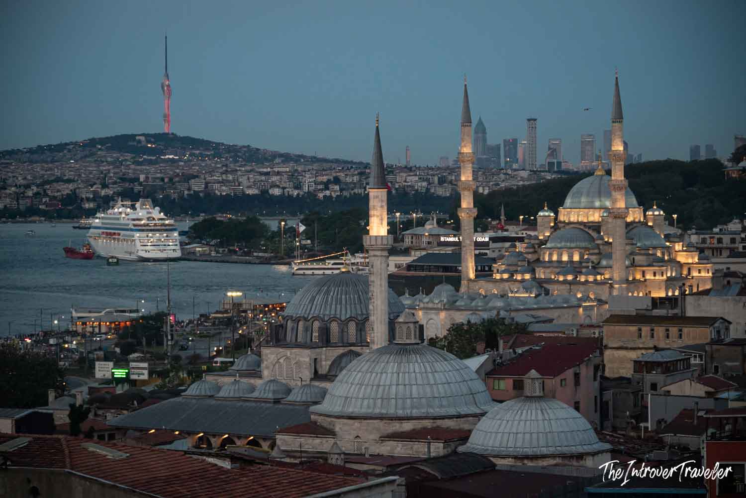 Rustem Pasha and New Mosque domes glowing at dusk above the Bosphorus, Istanbul skyline beyond