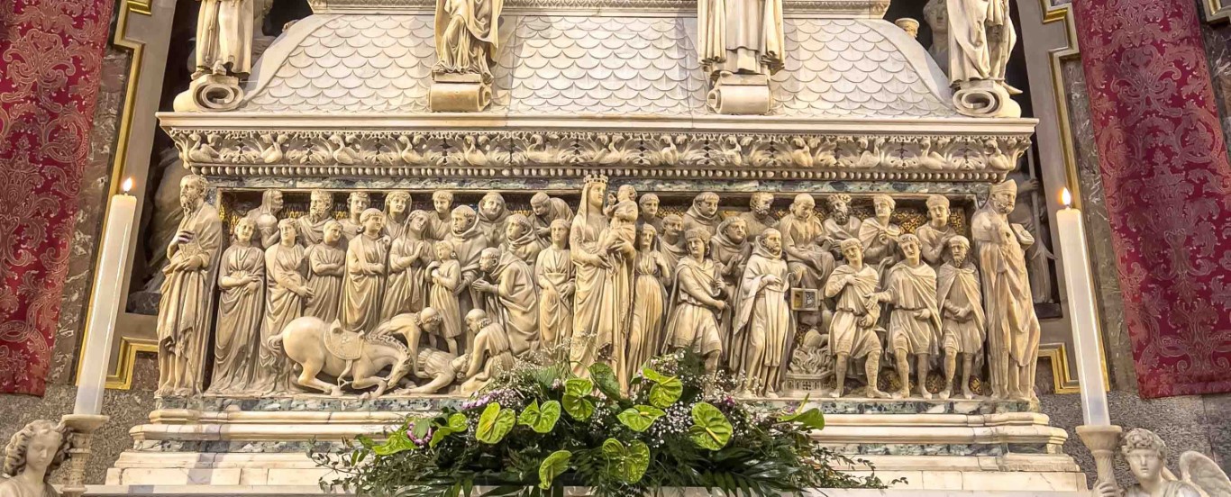 Marble relief panel on the Arca di San Domenico, Bologna, depicting saints and miracles in Gothic sculptural style