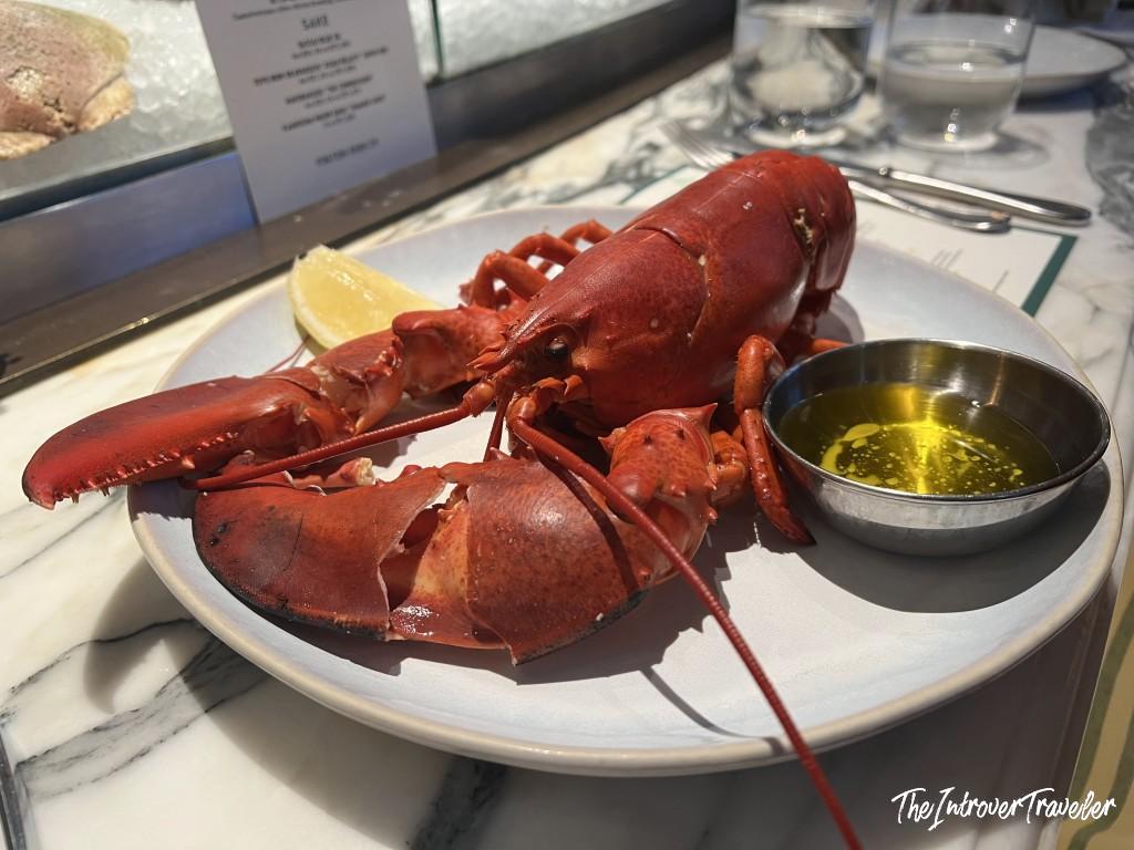 Whole steamed lobster with melted butter and lemon at Fulton Fish Bar, Pier 17, New York