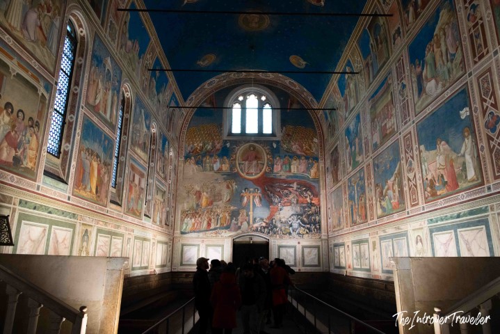 Interior of the Scrovegni Chapel in Padua, showing Giotto's vivid blue frescoes covering all walls and ceiling