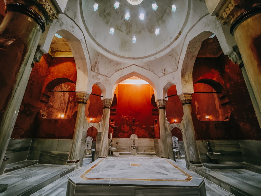 Interior of a historic Istanbul hammam, marble slab and domed ceiling with star-shaped skylights