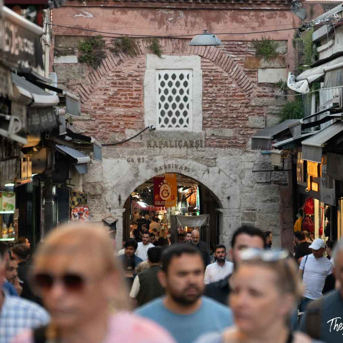 Crowded entrance to the Grand Bazaar (Kapalıçarşı) in Istanbul, with the historic stone gate arch visible