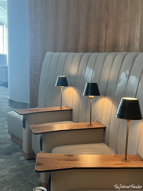 Plush leather booth seating with small table lamps at the IGA Lounge, Istanbul Airport