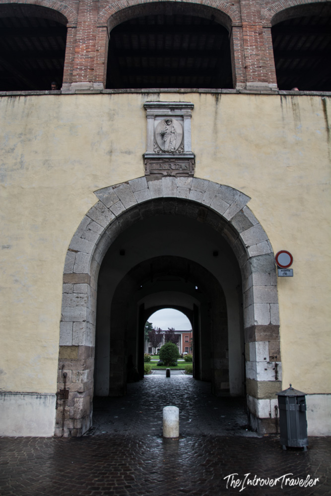 Stone archway of Porta San Pietro in Lucca with LIBERTAS inscription above the passage