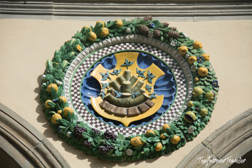 Glazed terracotta roundel by della Robbia on a Pistoia building, decorated with fruits and a heraldic motif
