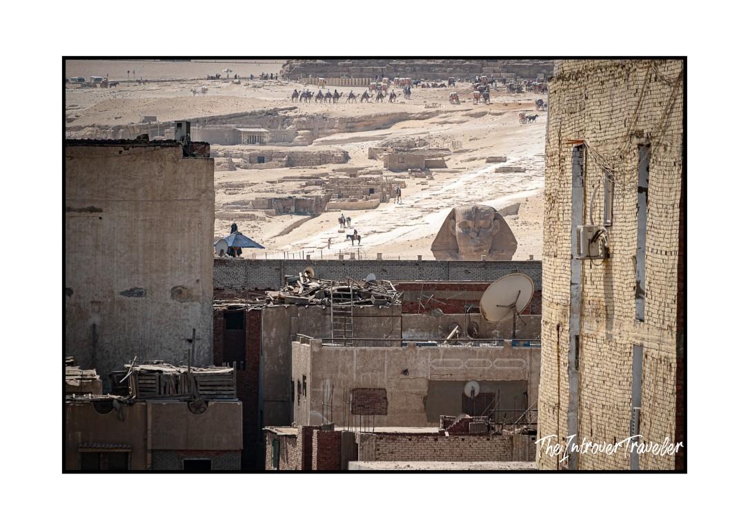 Great Sphinx of Giza rising behind Cairo rooftops, blending ancient and modern Egypt