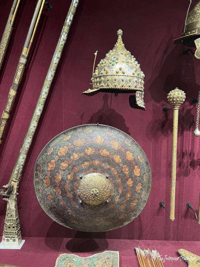 Jewel-encrusted Ottoman helmet, circular shield, and ceremonial weapons displayed at Topkapi Palace, Istanbul