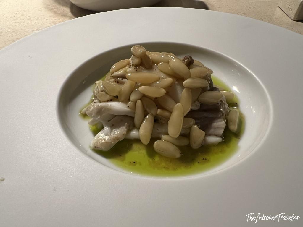 White fish fillet with pine nuts and herb oil, a fine dining dish at Trattoria Da Lucio in Rimini