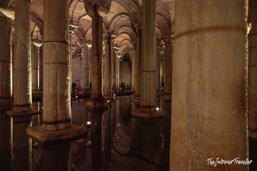 Basilica Cistern Istanbul, ancient columns reflected in still water beneath brick vaulted ceiling