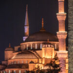 Blue Mosque illuminated at night, seen from near the Hagia Sophia in Istanbul