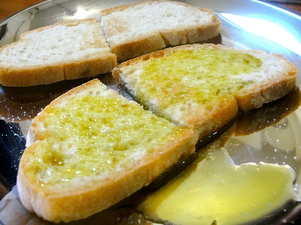 Tuscan bread slices drizzled with local olive oil, a staple of traditional Tuscan cuisine