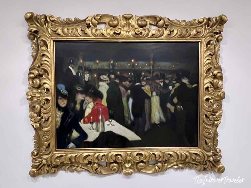 Picasso's Le Moulin de la Galette painting in an ornate gold frame at the Guggenheim New York