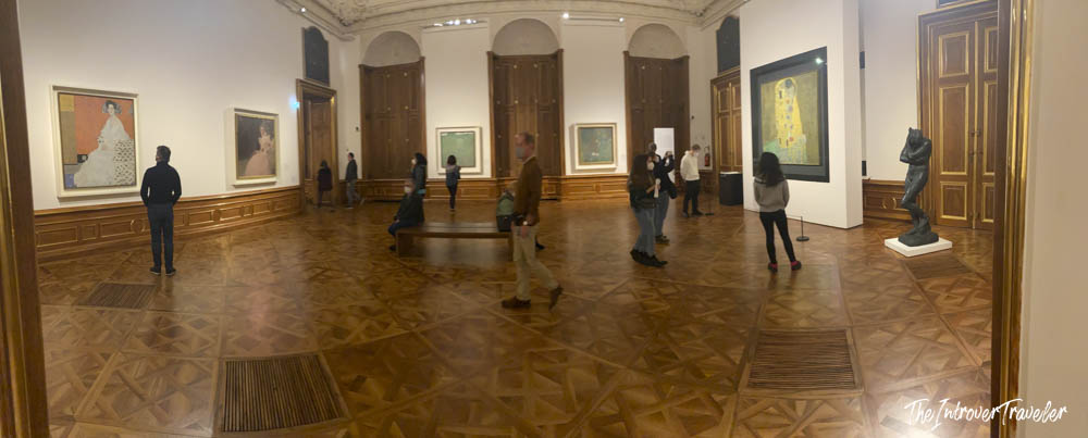 Visitors viewing Klimt paintings including The Kiss at the Belvedere Museum Vienna gallery room