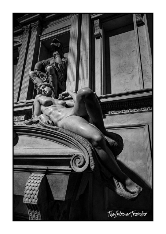 Michelangelo's Dawn sculpture reclining on the Medici Tombs in Florence's New Sacristy