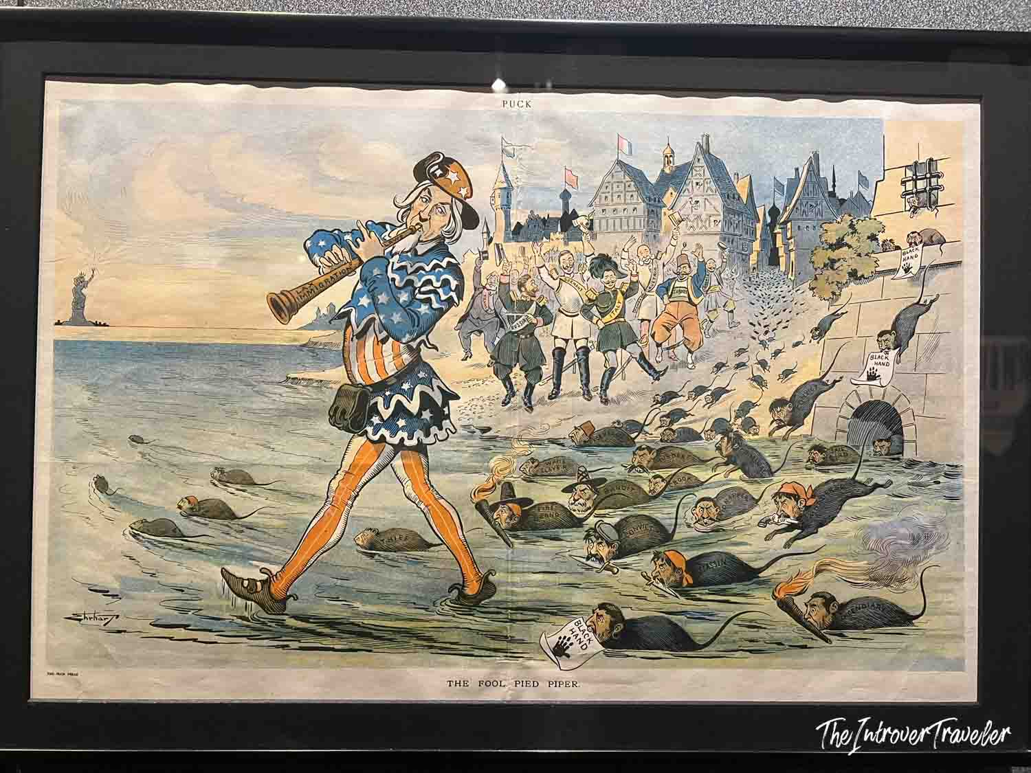 Puck magazine cartoon "The Fool Pied Piper" depicting Uncle Sam and immigration satire, displayed at Ellis Island Immigration Museum