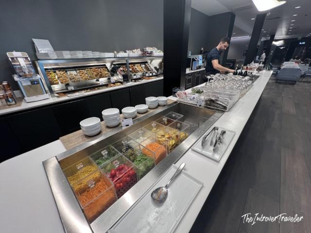 Salad bar and buffet spread inside the Leonardo Lounge at Milan Linate Airport