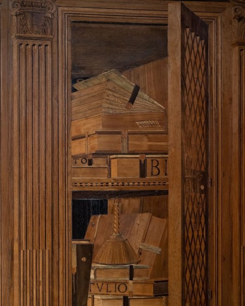 Intarsia wood panel in the Studiolo of Federico da Montefeltro, showing shelves with books and boxes