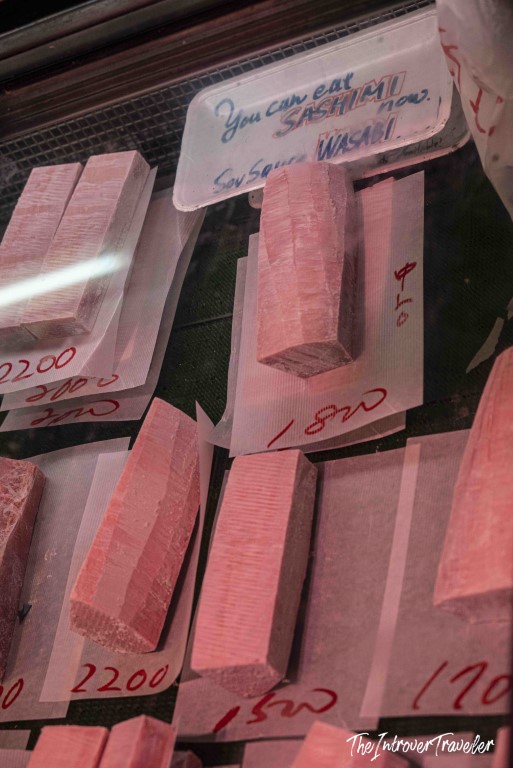 Fresh tuna blocks for sashimi with price tags at Tsukiji fish market, Tokyo