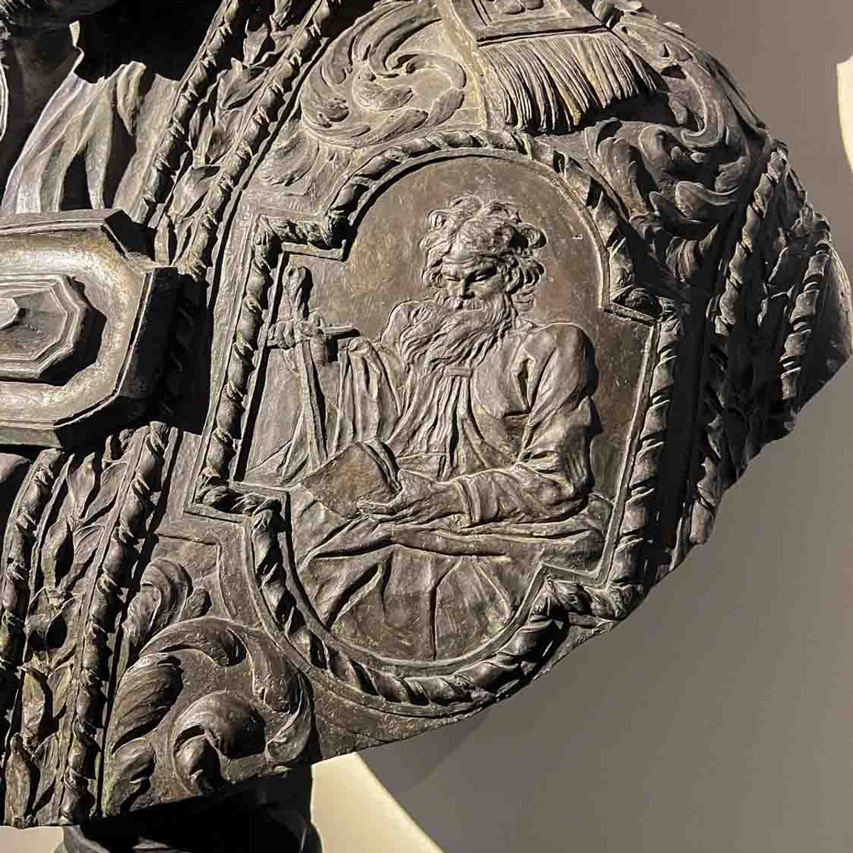 Close-up of intricate bronze armor relief at the Bernini and Barberini exhibition, Palazzo Barberini
