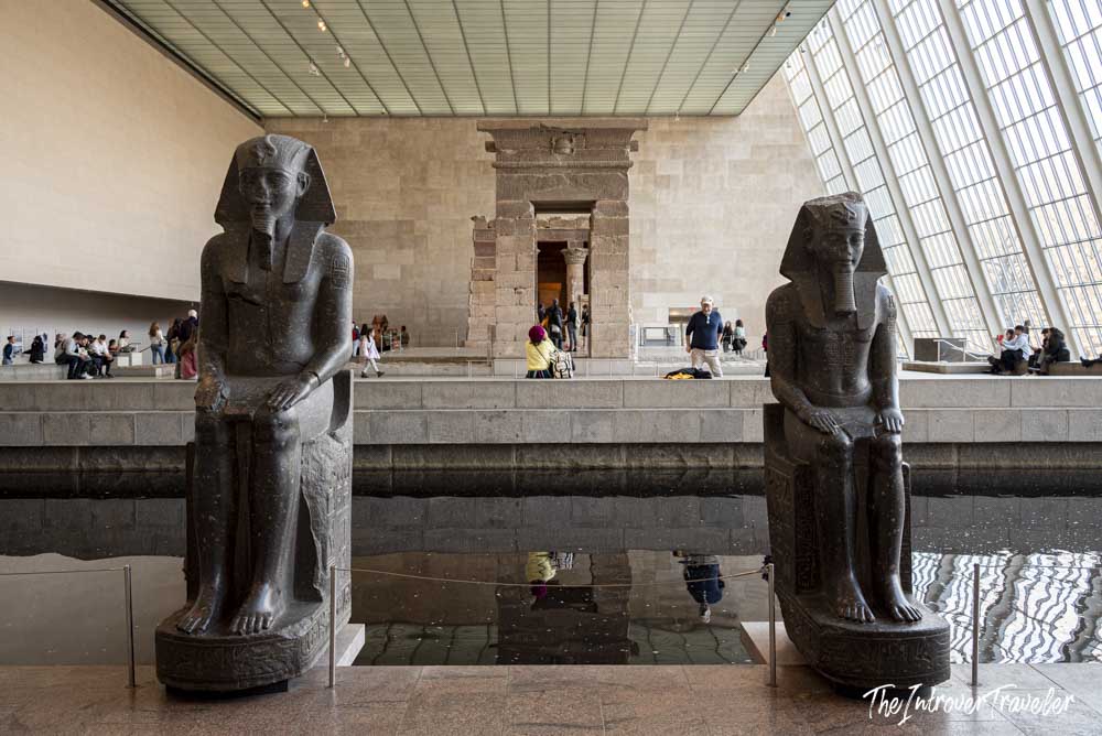 Temple of Dendur with flanking Egyptian statues reflected in the pool, Met Egyptian Wing