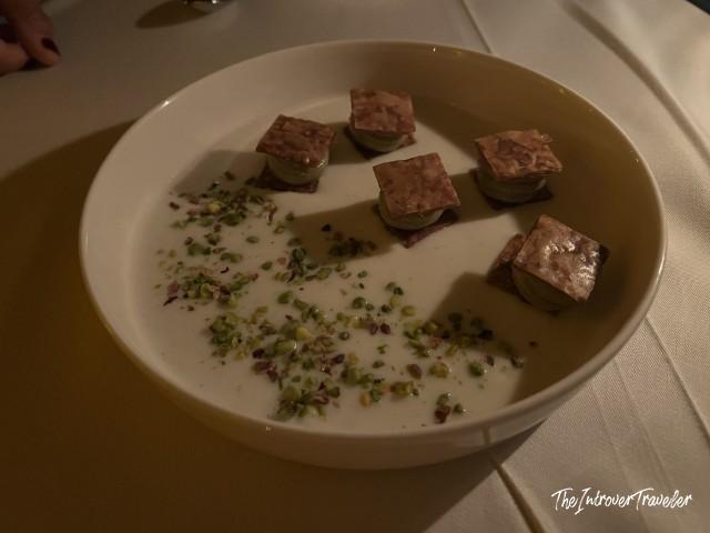 Elegant starter course at Lokanta 1741, Istanbul, with pistachio crumble and layered bites in cream sauce