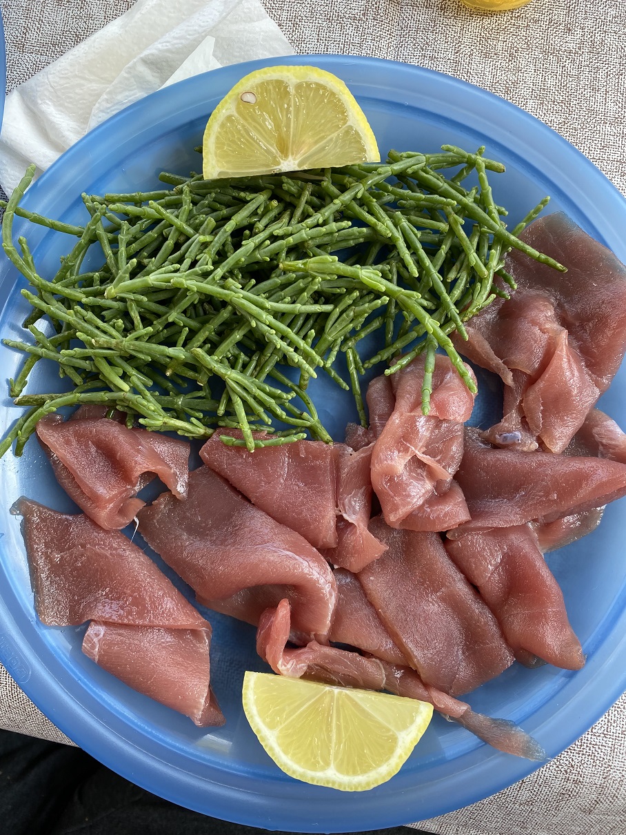 Raw tuna slices with sea asparagus and lemon, a local specialty in the Three Aci, Sicily