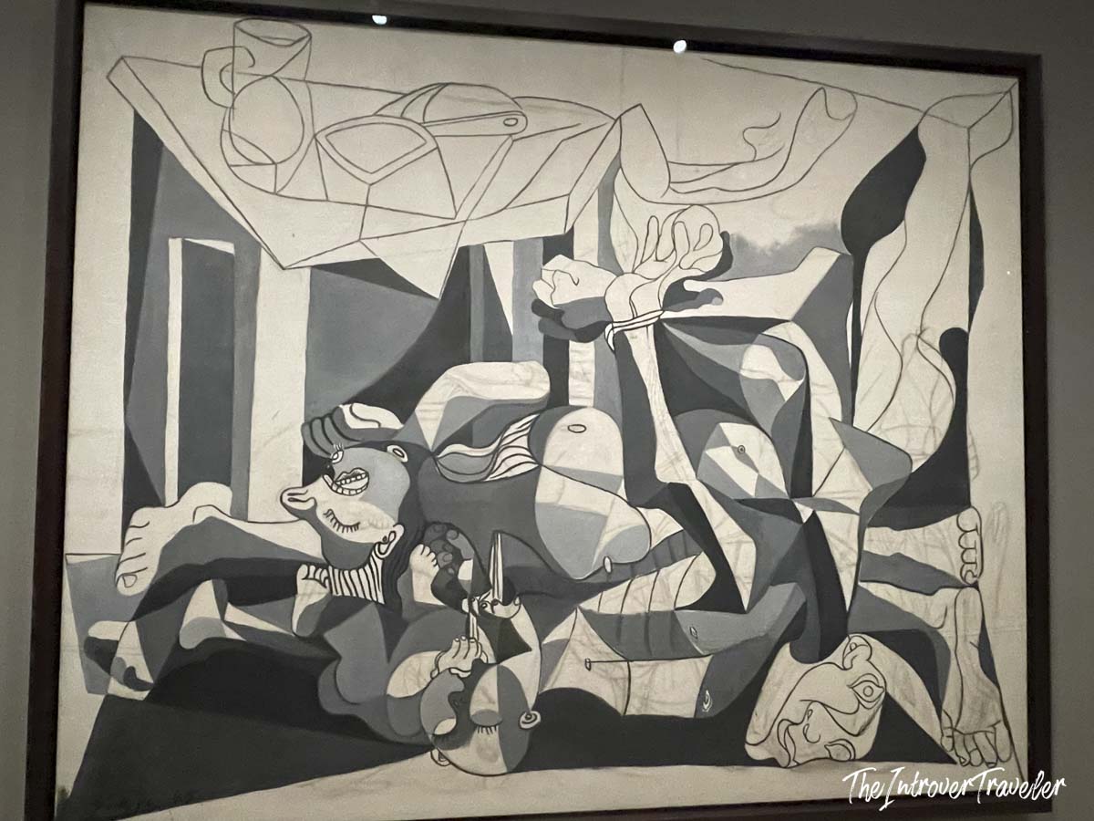 Charnel House by Pablo Picasso, a monochromatic cubist war painting displayed at MoMA New York