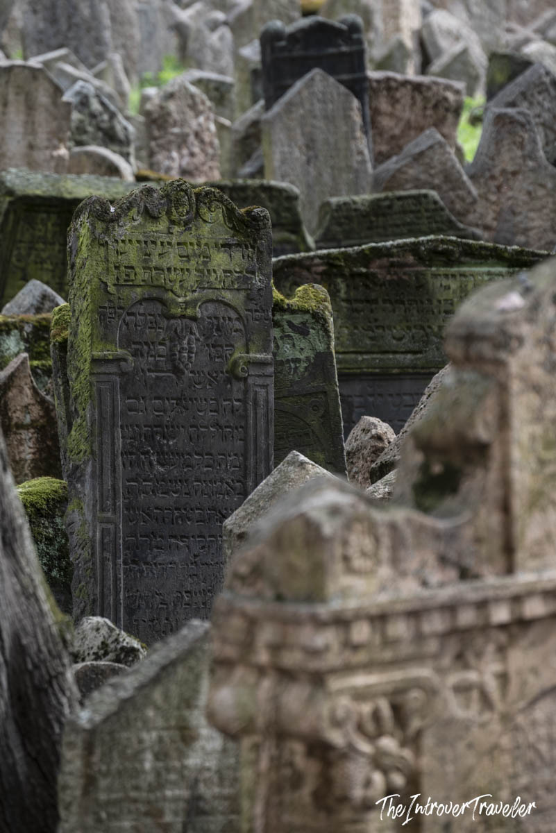 Moss-covered Hebrew gravestones crowded together at the Old Jewish Cemetery in Prague